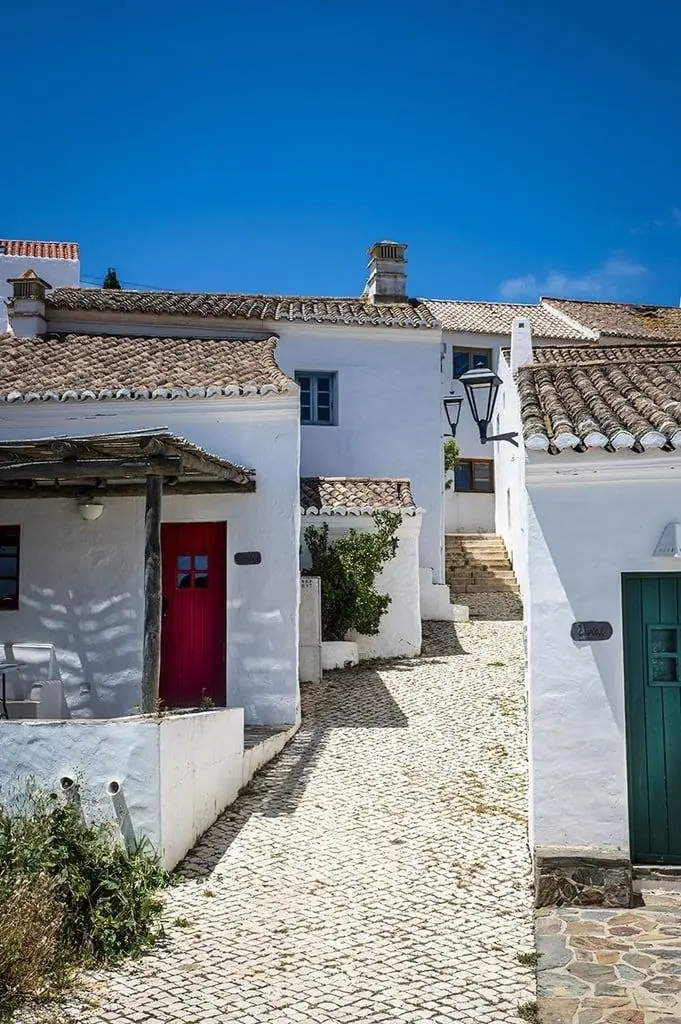 Whitewashed cobbled street in the restored hamlet of Aldeia da Pedralva