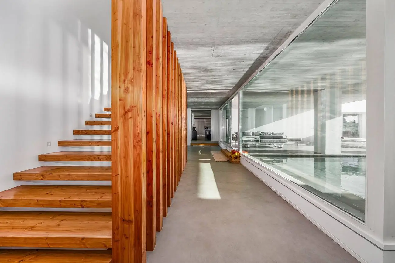Timber-screen corridor with floating staircase